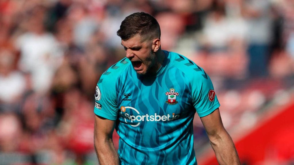 Southampton FC goalkeeper Fraser Forster in turquoise kit shouting during intense football match wallpaper