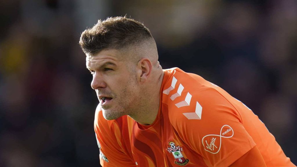 Southampton FC goalkeeper Fraser Forster in vibrant orange kit intense focused pose wallpaper