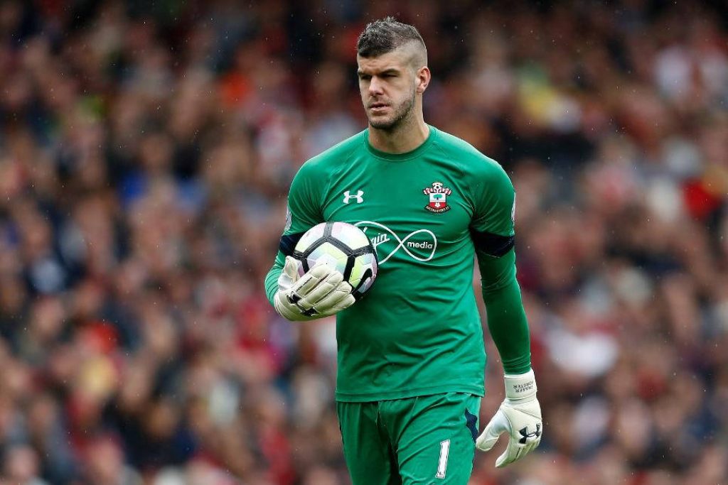 Southampton FC goalkeeper Fraser Forster in green kit holding soccer ball in stadium wallpaper