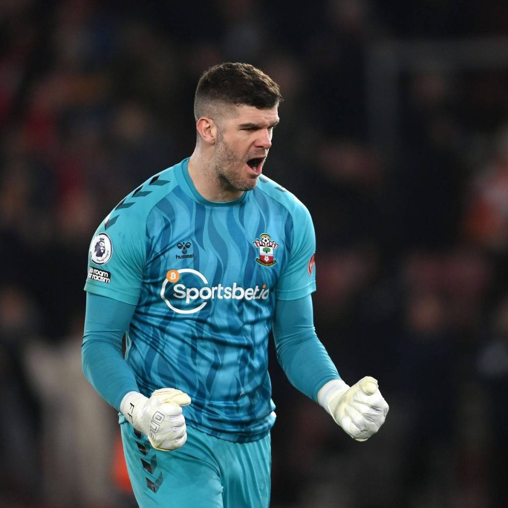 Southampton goalkeeper Fraser Forster in teal kit shouting passionately during football match Wallpaper