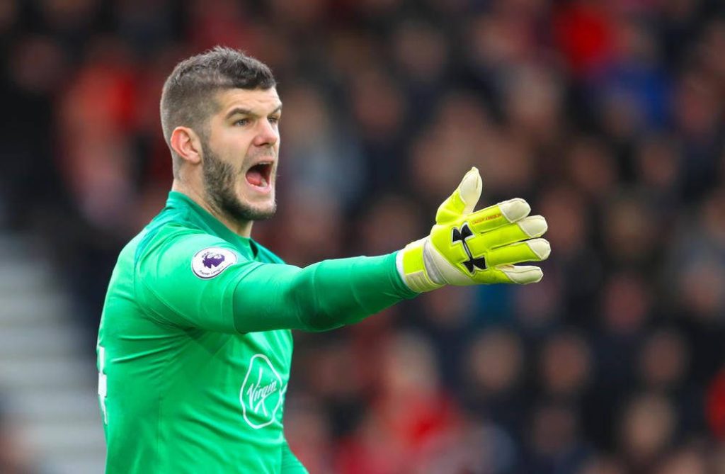 Goalkeeper Fraser Forster in neon green Southampton kit directs defense mid-shout in match Wallpaper