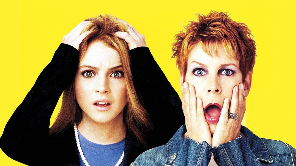 Freaky Friday wallpaper featuring Lindsay Lohan and Jamie Lee Curtis shocked expressions yellow background