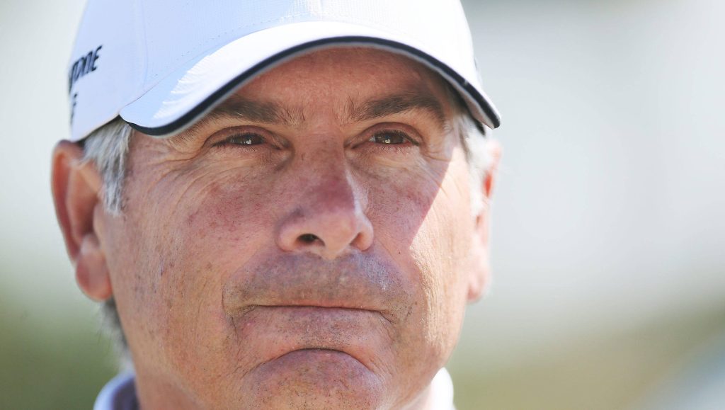 Fred Couples close-up portrait in white cap with focused expression golf legend wallpaper background