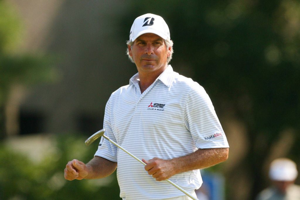 Fred Couples focused on green holding putter wearing Bridgestone cap and golf polo wallpaper