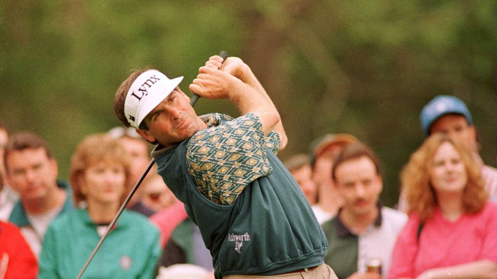 Fred Couples mid-swing in Lynx visor Ashworth sweater with blurred golf spectators behind wallpaper