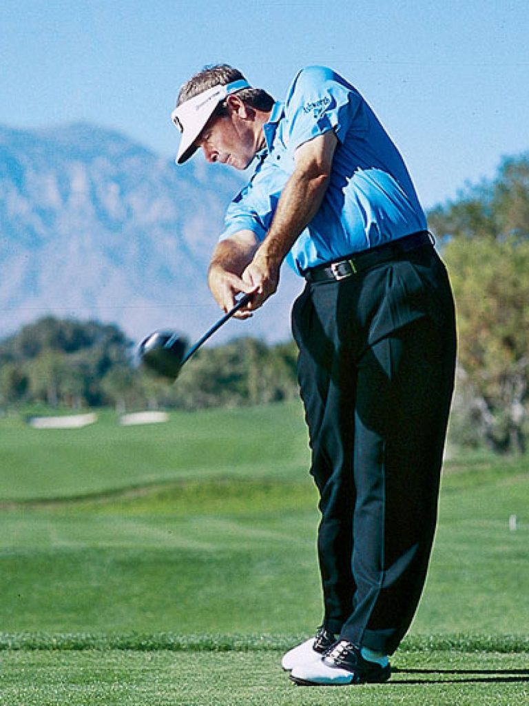 Fred Couples iconic golf swing on sunny course with mountain backdrop high-quality wallpaper