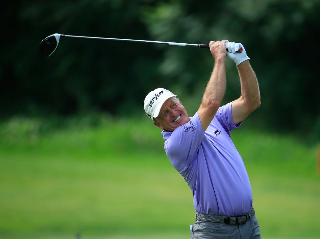 Fred Funk mid-swing golf wallpaper purple polo white Stryker cap green course background