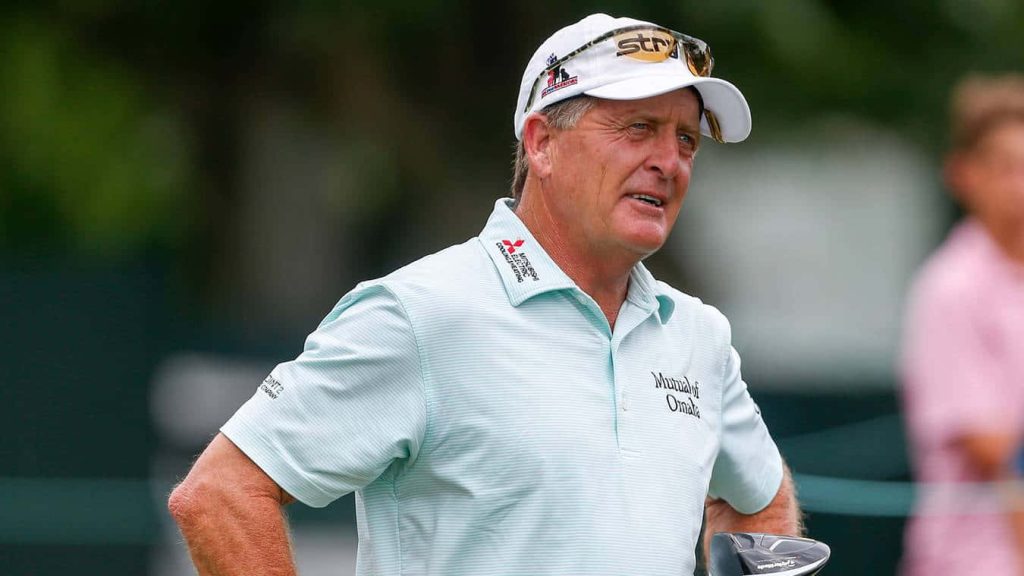 Professional golfer Fred Funk wearing light blue polo and white cap on golf course background Wallpaper