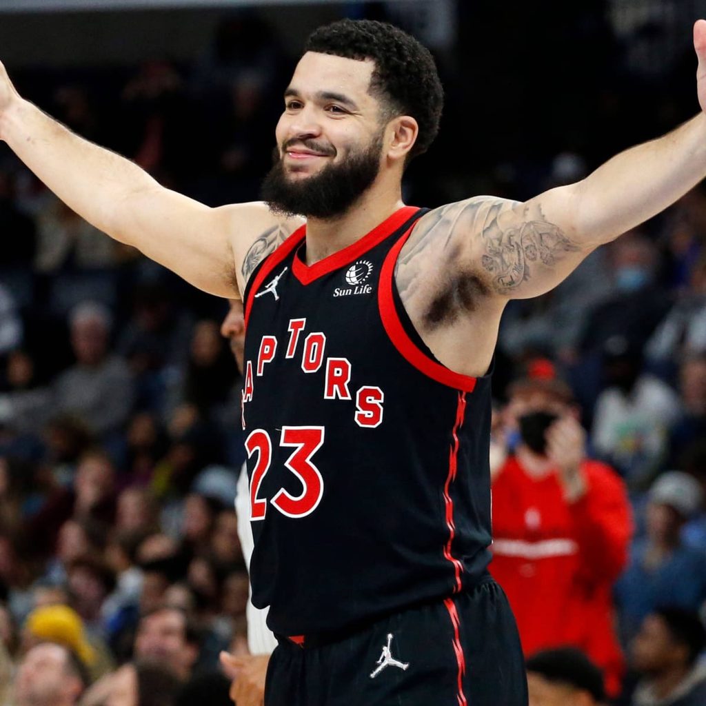 Fred VanVleet Toronto Raptors jersey 23 celebrating victory with arms raised in vibrant arena Wallpaper