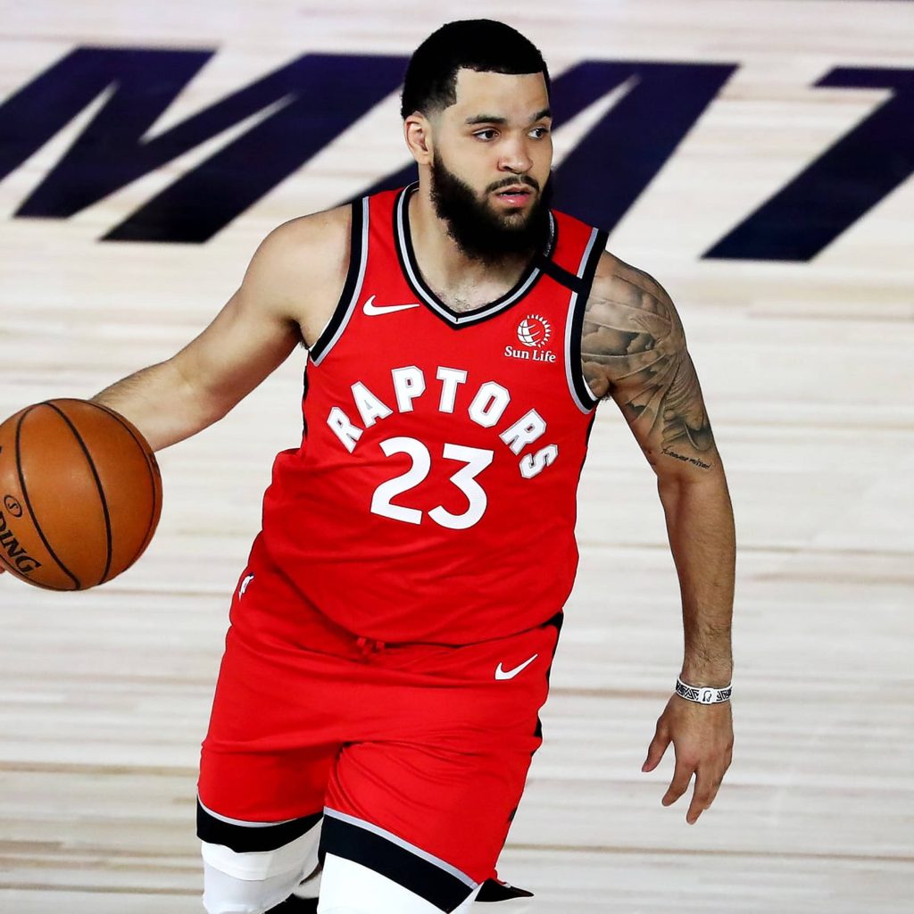 Fred VanVleet dribbling basketball in red Raptors jersey number 23 intense game action wallpaper