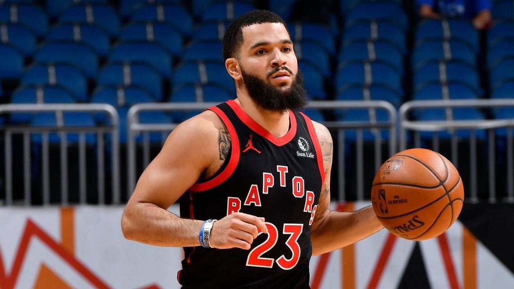 Fred VanVleet in Toronto Raptors jersey dribbling basketball in action with blurred arena background Wallpaper