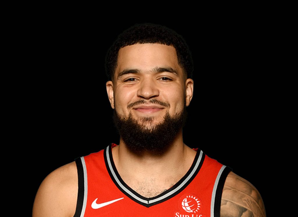 Fred VanVleet in red Raptors jersey with Sun Life patch smiling on black background wallpaper