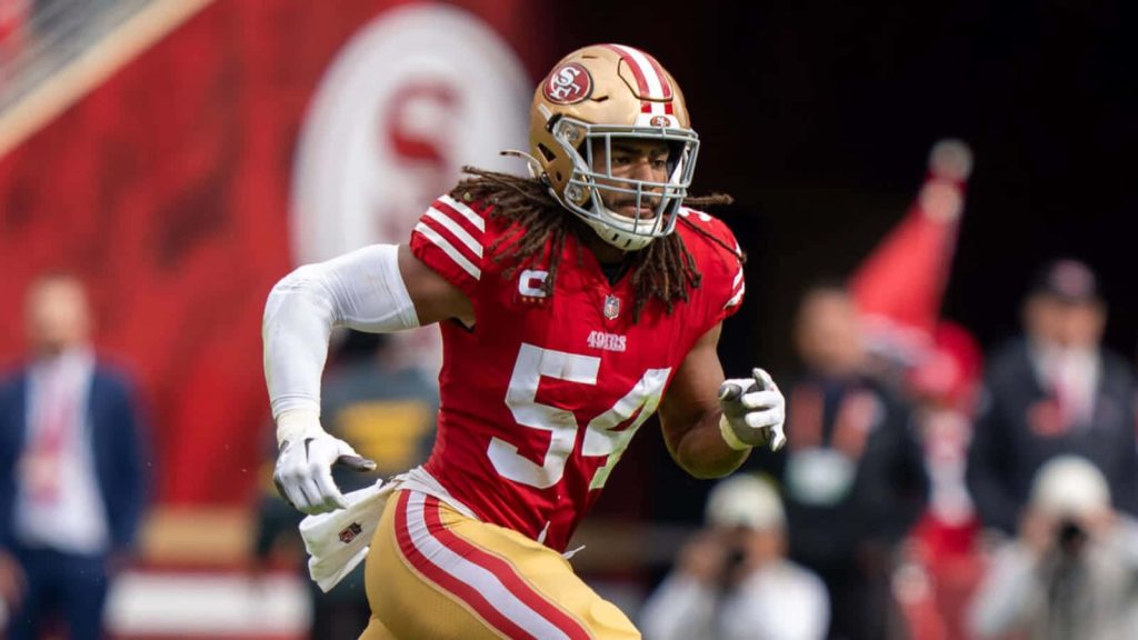 Fred Warner San Francisco 49ers number 54 running in red and gold jersey NFL intense football action Wallpaper