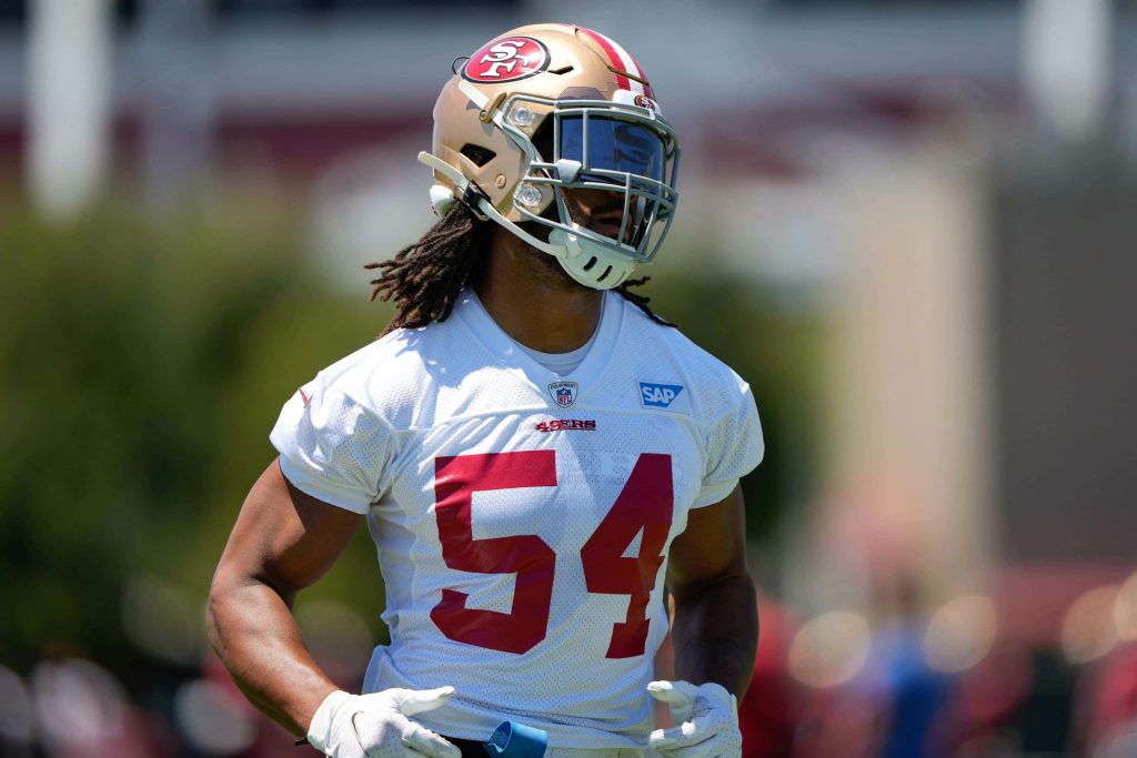 San Francisco 49ers linebacker Fred Warner in gold helmet white jersey practice wallpaper background