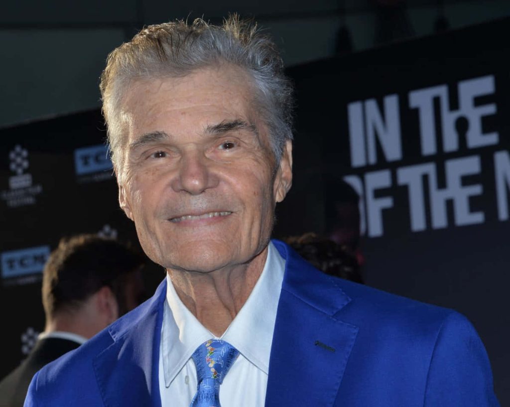 Fred Willard smiling on red carpet in blue suit and cocktail tie high-quality portrait wallpaper