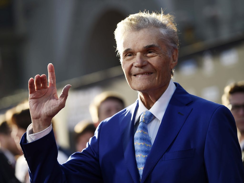 Fred Willard smiling waving in blue suit with cocktail tie red carpet portrait wallpaper