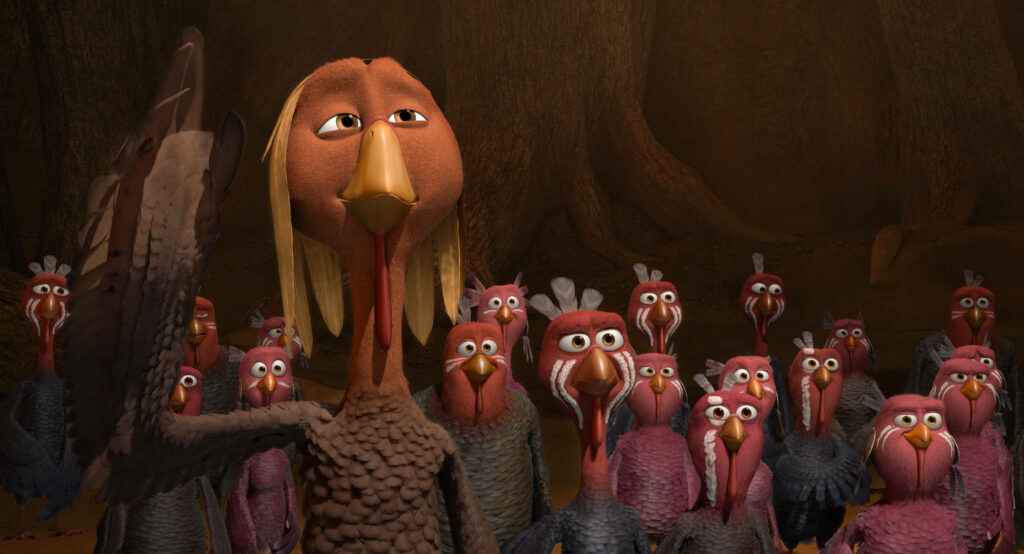 Playful Animated Turkeys from Free Birds in Forest Setting Wallpaper