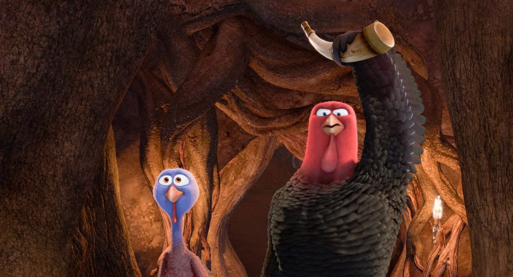 Free Birds wallpaper of muscular turkey Jake with horn and purple Reggie in dark forest background