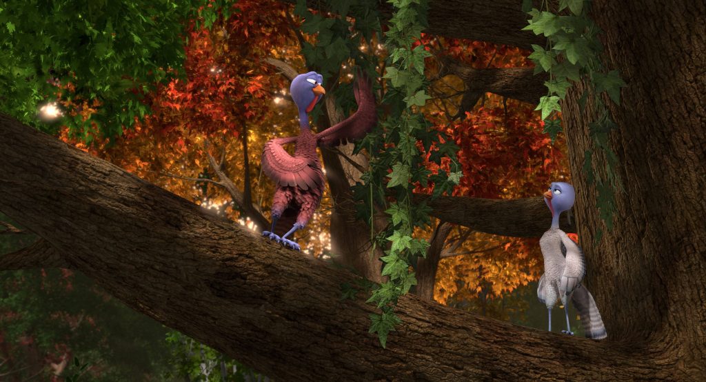Free Birds CGI characters Reggie and Jake on branch with autumn leaves vibrant forest background Wallpaper