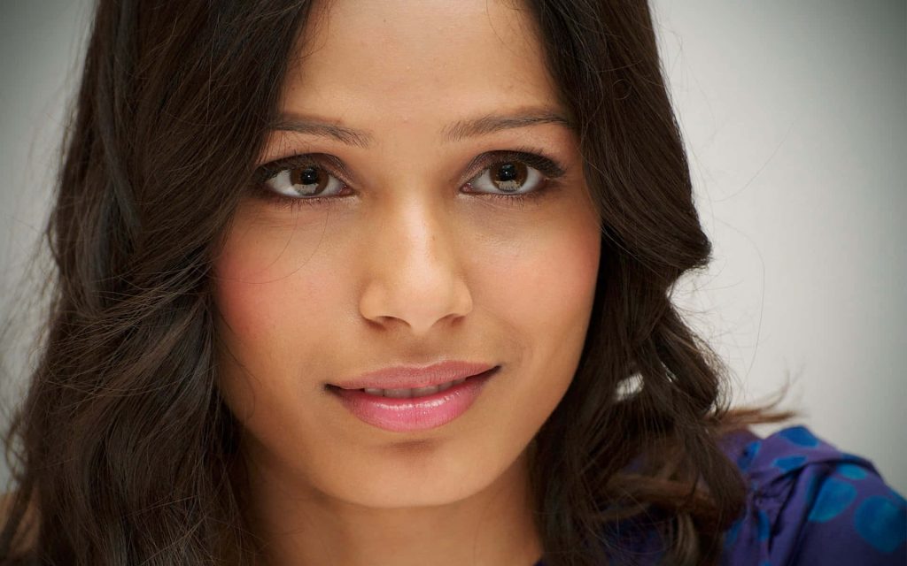 Close-up portrait of Freida Pinto with soft lighting showcasing her natural beauty and elegance Wallpaper