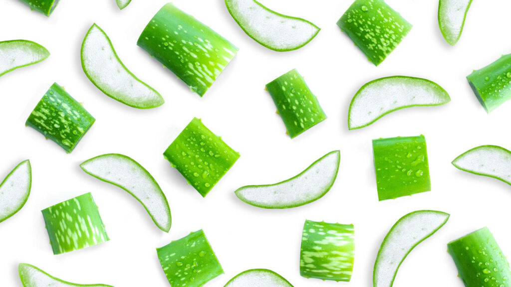 Fresh Aloe Vera slices pattern on white background highlighting natural texture and freshness Wallpaper