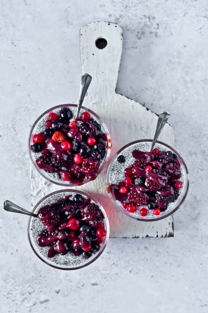 Delightful Wallpaper: Fresh Berries Over Creamy Dessert in Glass Cups
