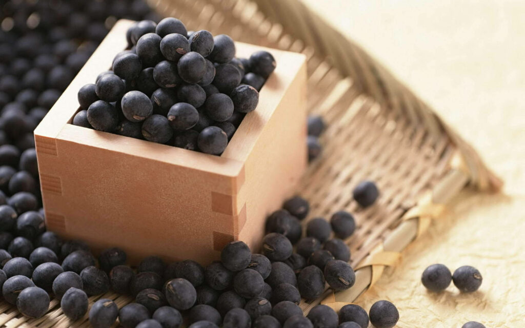 Wooden sake box overflowing with fresh blueberries on woven mat natural rustic background Wallpaper