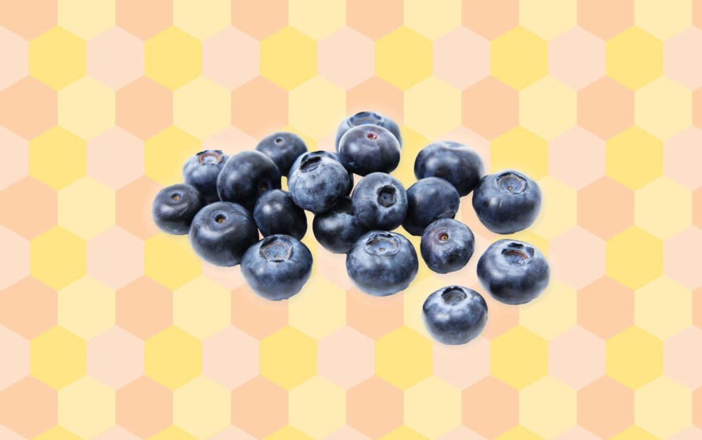 Fresh ripe blueberries cluster on pastel hexagonal summer-themed wallpaper background