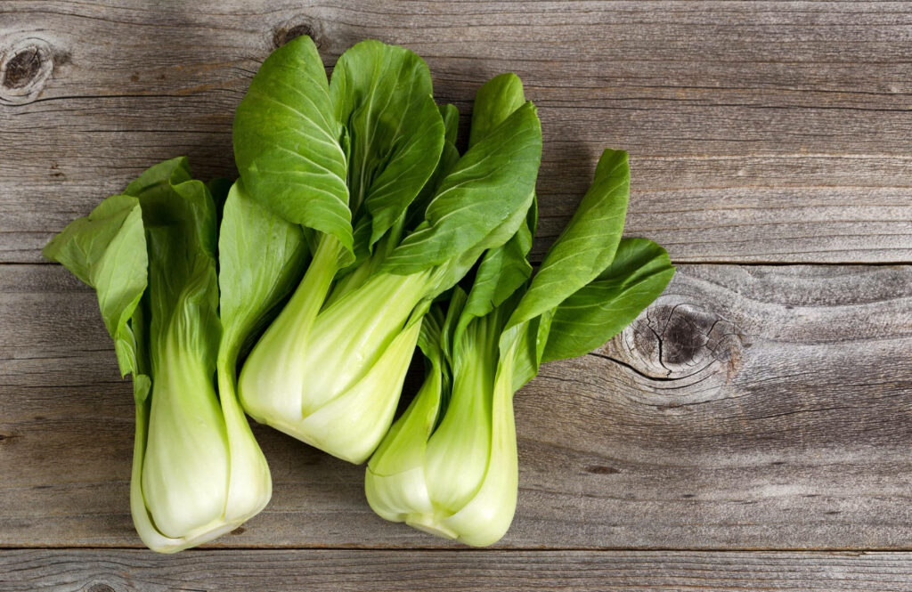 Fresh Bok Choy Wallpaper: Vibrant Aesthetic on Rustic Wood Background