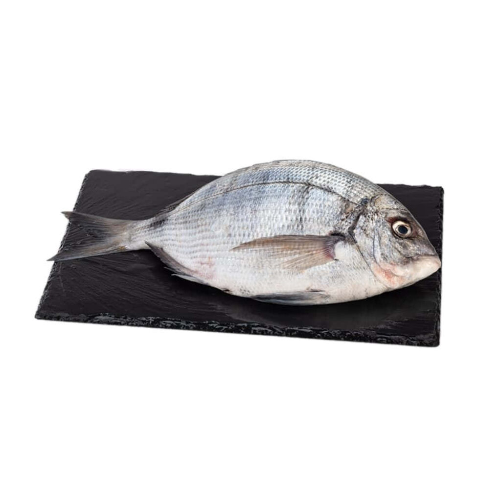 Fresh bream fish on black slate wallpaper showcasing silvery scales perfect for seafood decor