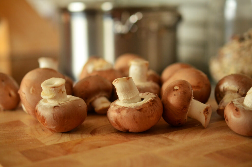 Fresh Button Mushrooms on Wood: Cooking-Themed Wallpaper Background