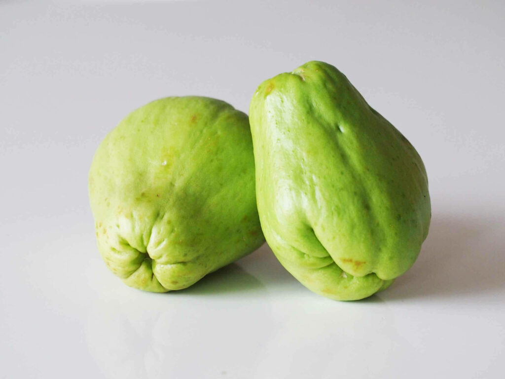 Fresh Green Chayote Wallpaper: Vibrant Vegetables on White Background