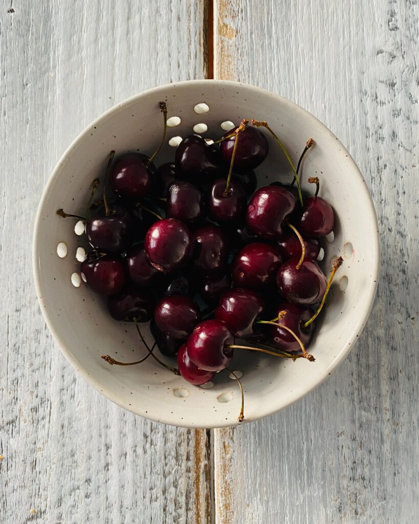 Juicy Cherry Wallpaper: Fresh Plate on Rustic Wood Background