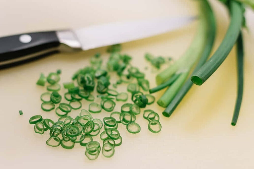 Fresh Chives Wallpaper: Vibrant Culinary Background with Knife & Stalks