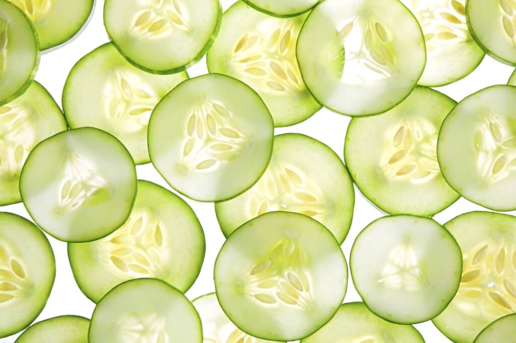 Fresh cucumber slices pattern on white background crisp translucent green edges wallpaper