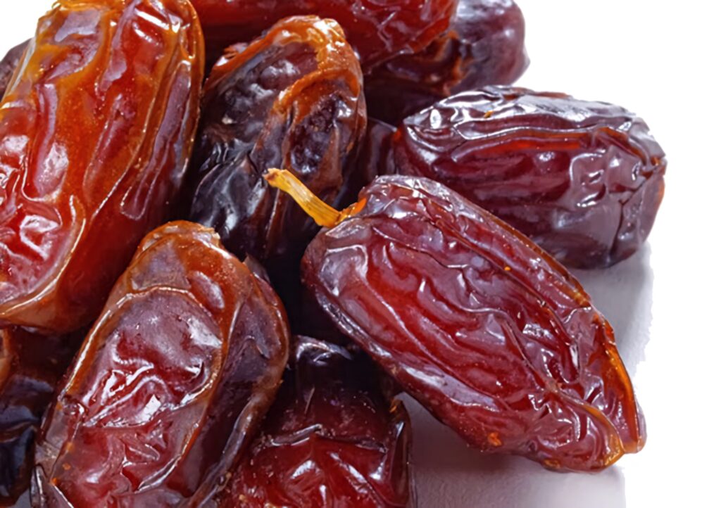 Close up of glossy fresh dates showing detailed wrinkled texture and rich brown tones wallpaper