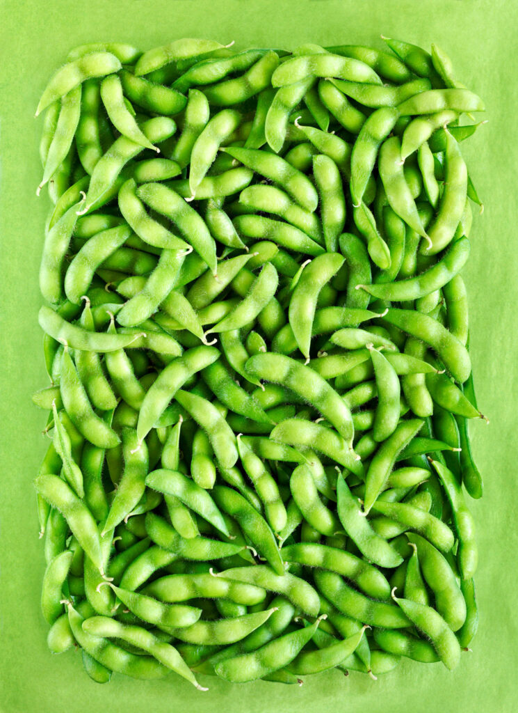 Vibrant fresh edamame beans arranged in a square pattern healthy green wallpaper background