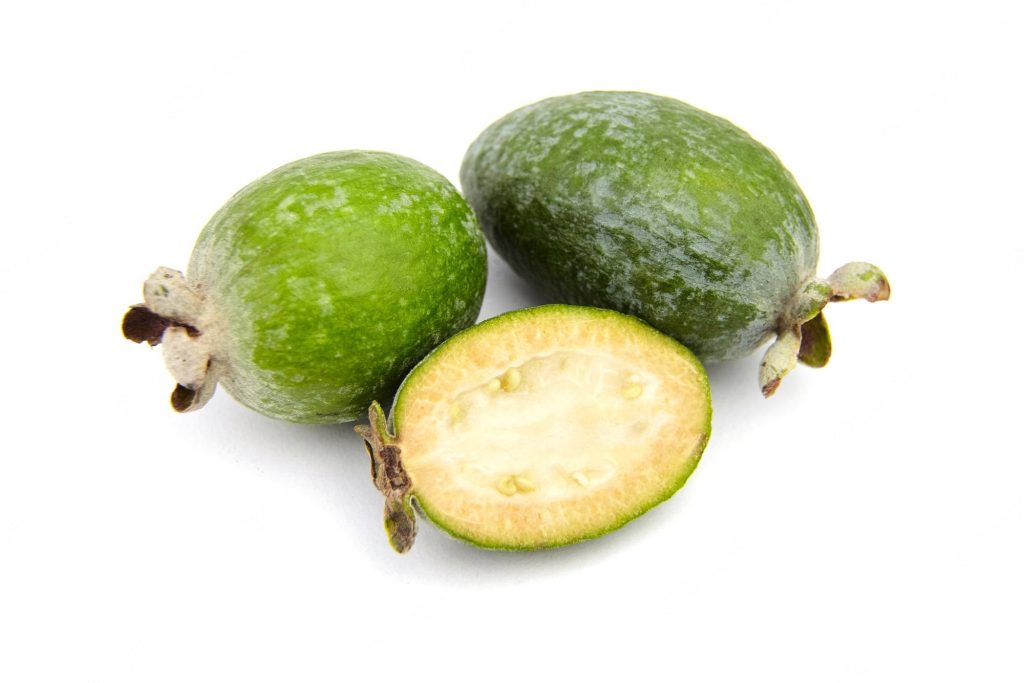 High-resolution food wallpaper with three fresh feijoas green whole fruits and creamy slice