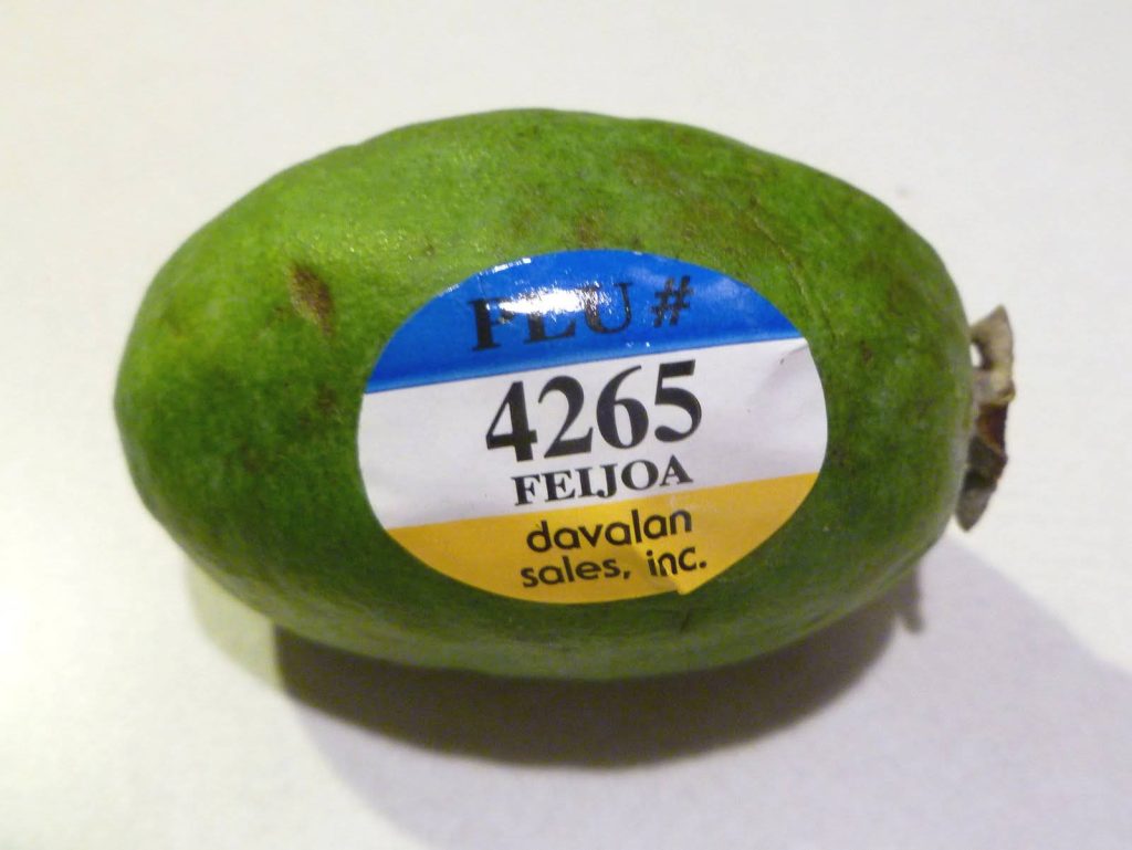 High-resolution fresh feijoa with Davalan Sales Inc sticker PLU 4265 on light background Wallpaper