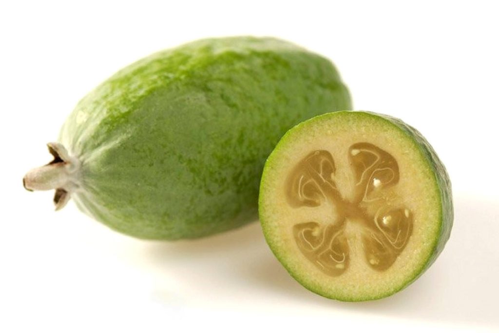 Fresh Feijoa Sellowiana fruit whole and halved on white background high-resolution wallpaper