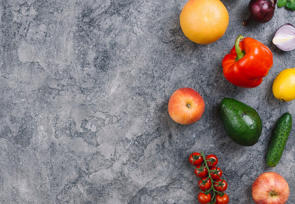 Colorful fresh fruits and vegetables including red bell pepper avocado grapefruit tomato apple cucumber Wallpaper