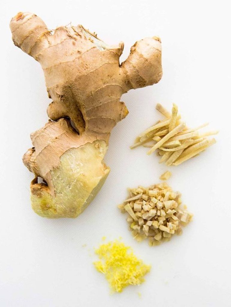 Fresh ginger root shown whole peeled julienned chopped and minced on white background top view Wallpaper