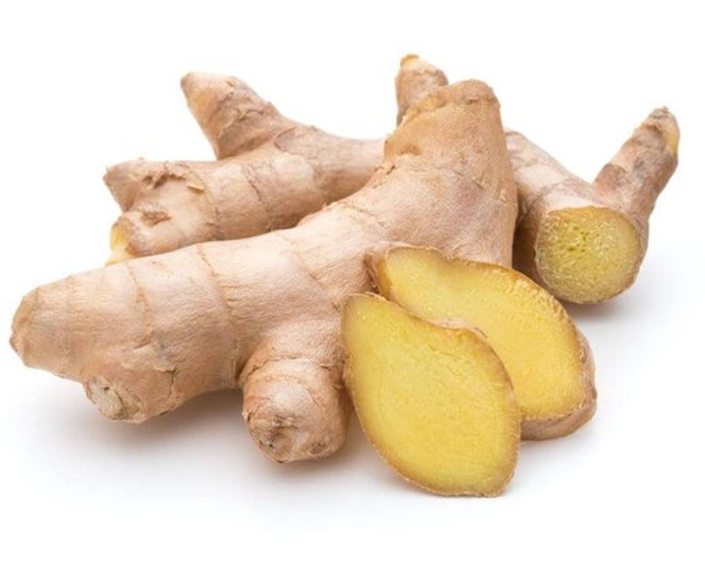 Fresh harvested ginger roots whole and sliced bright yellow interior on white background wallpaper