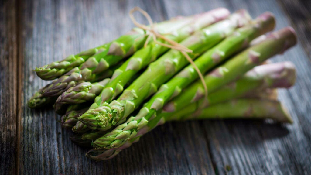 Vibrant Green Asparagus Bundle on Rustic Wood - Wallpaper Background