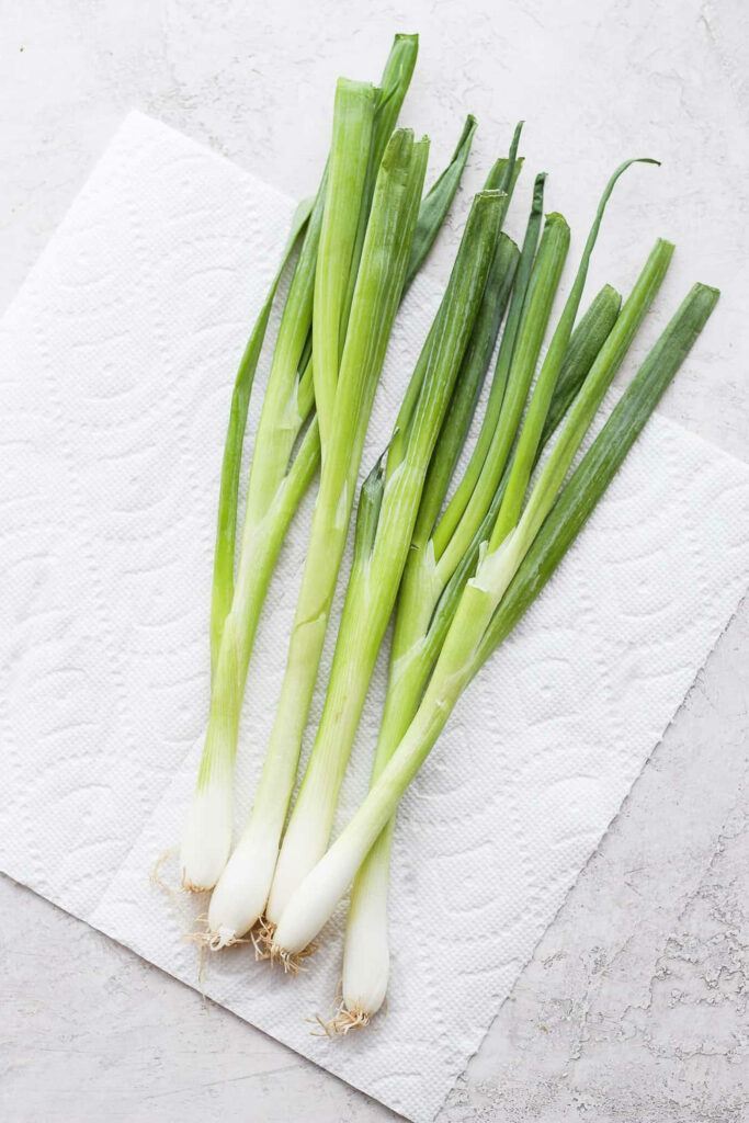 Fresh Green Onions Flat Lay: Wholesome Wallpaper Background