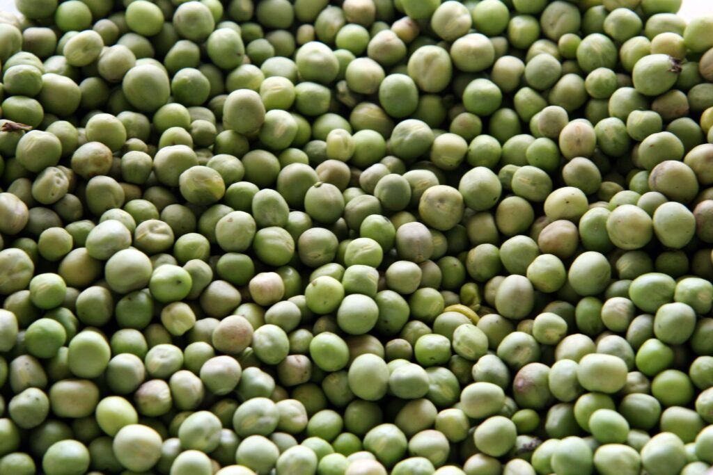 Fresh Green Peas Close-Up: Vibrant Texture Wallpaper Background