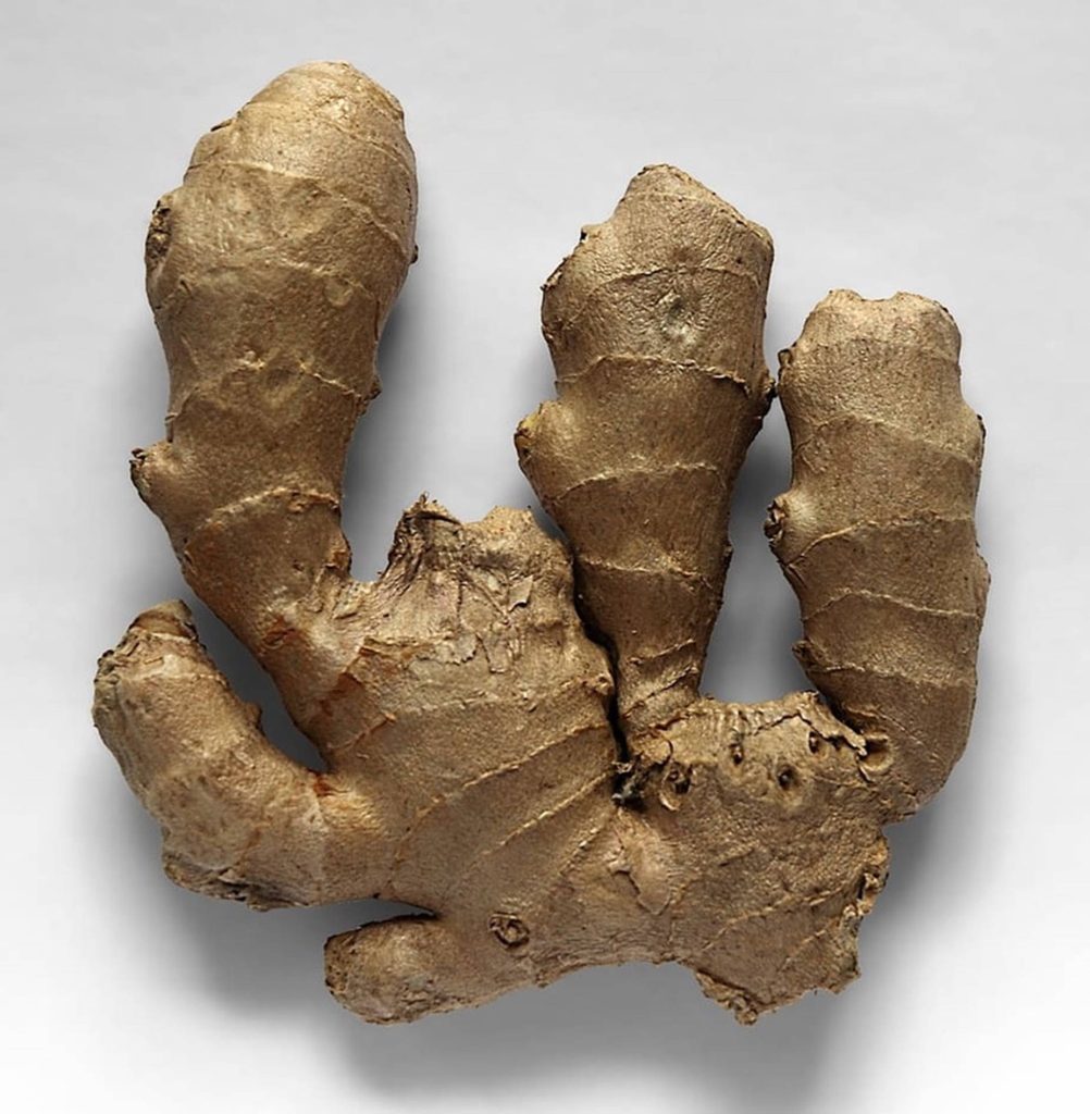 Top view of fresh knobby ginger root with earthy textures on clean neutral background wallpaper
