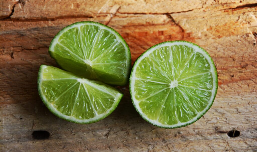Juicy Lime Wallpaper: Close-Up on Rustic Wood Background