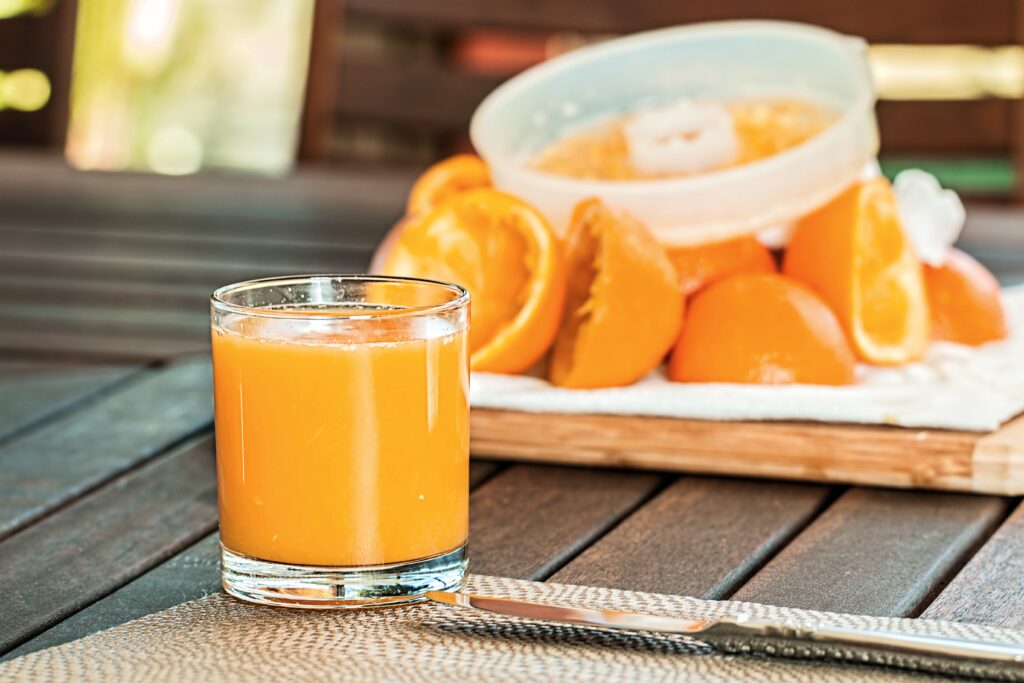 Refreshing Orange Juice Wallpaper: Glass, Slices & Juicer Decor