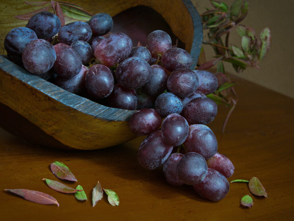 Vibrant Purple Grapes in Rustic Bowl - Warm Wallpaper Background